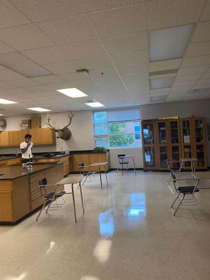 One of Fajardos classrooms in the high school with one of his classmates. This shows a stark difference in seating arrangements from before COVID-19.