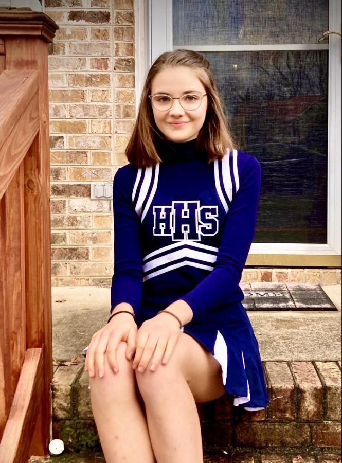 Healy Poses in her cheerleading uniform on the steps of her childhood home.