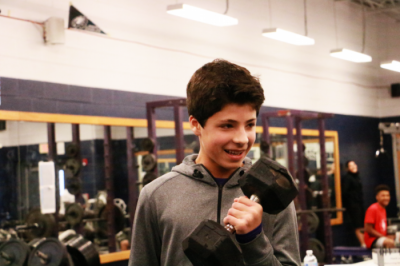 Now sernior Aidan Perkins does a workout during weightlifting class in his freshman year