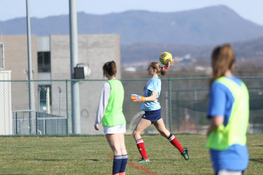 During a practice before the cancellation of their season last spring, current senior Amelia Mitchell scoops up a ball while playing goalkeeper in a scrimmage.