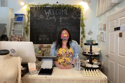 Owner Sara Christensen poses for a photo behind the front desk.