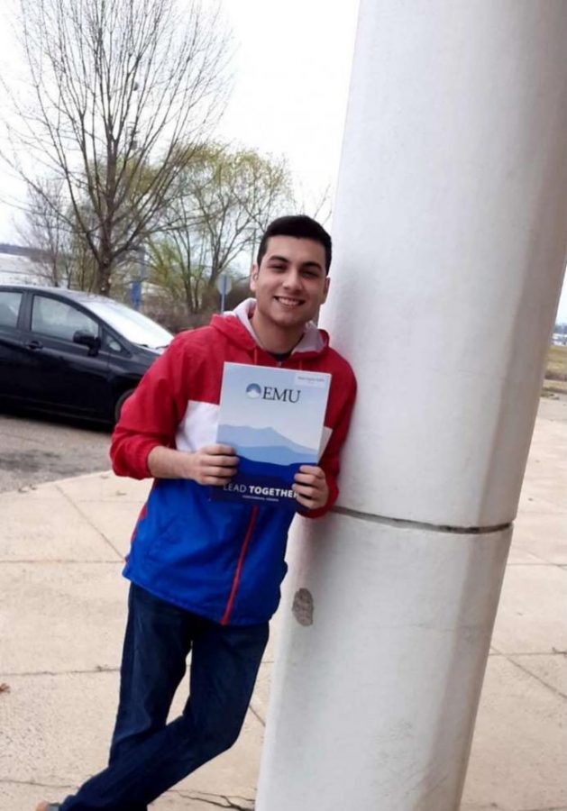 Senior Noel Ayala-Gallo poses with his acceptance packet from Eastern Mennonite University. 