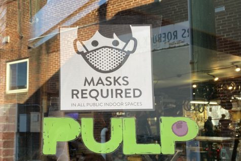 Like many other stores downtown, Shenandoah Bicycle Company has signs out front letting customers know they have to wear a mask in the store. 