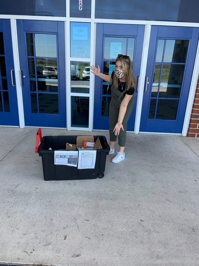 Junior Juju Butler poses outside the school for a HOSA food bank event.