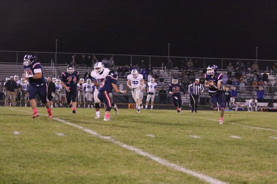 Senior Keenan Glago runs with the ball, getting the Streaks a first down.
