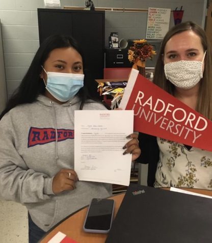 Senior Crystal Castelan-Rafael (left) poses with a Radford University representative after receiving her acceptance during Virginia College Application Week.
