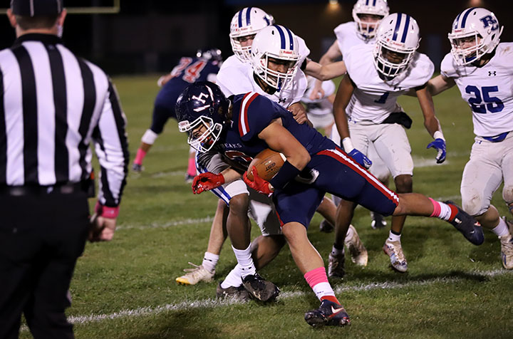 Senior Dante Edwards runs the balls while Rockbridge players attempt to tackle him.