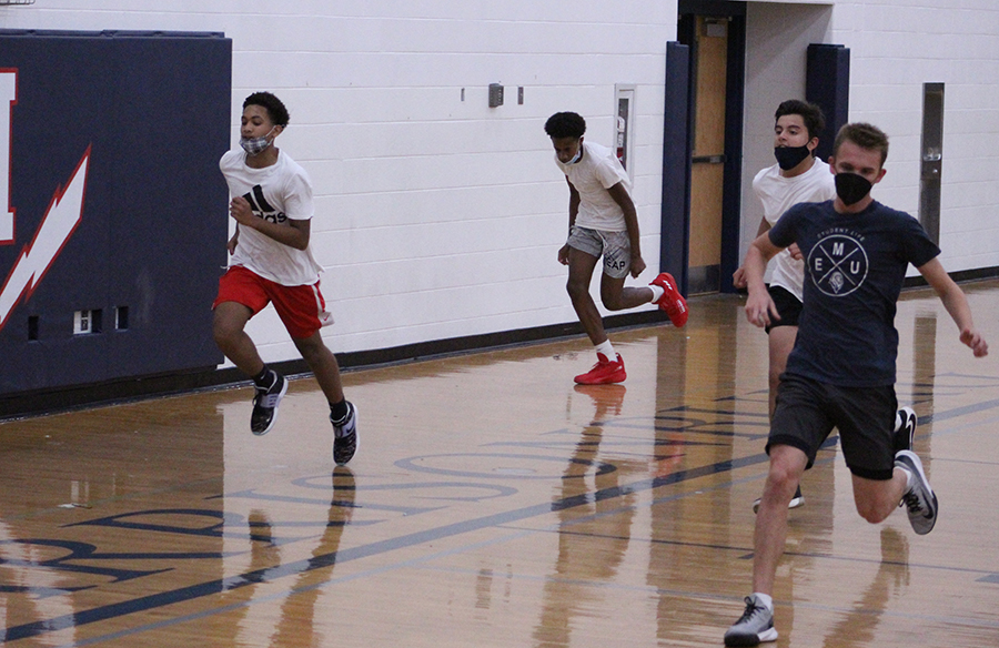 Freshman Tyler Sprague (far left) and Latham Fields (second from left) do conditioning at the end of tryouts.