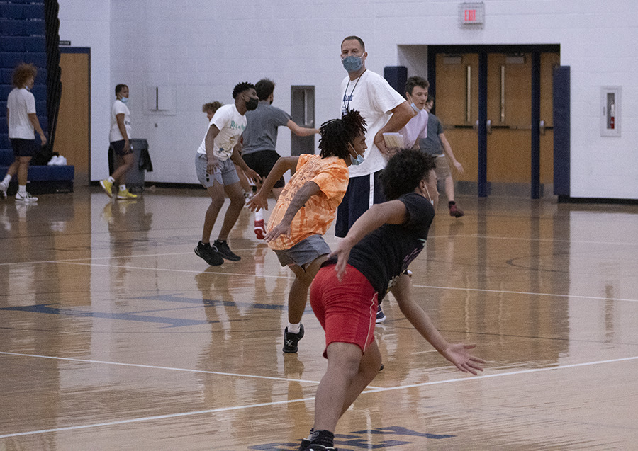 Junior Kris Walker (right) and junior Zion Cruce (left) work on defense at tryouts.