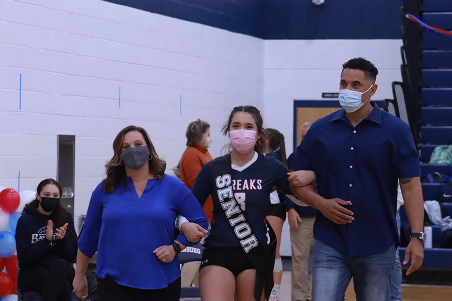 Senior Juju Butler is escorted by her parents TJ and Tanya Butler. 