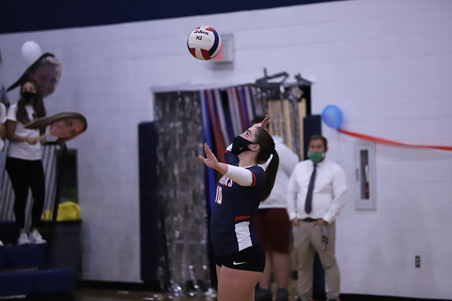 Senior Maya Waid serves the ball. 