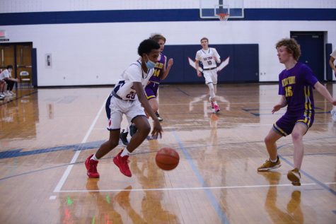 Freshman Latham Fields drives to the hoop against Patrick Henry.