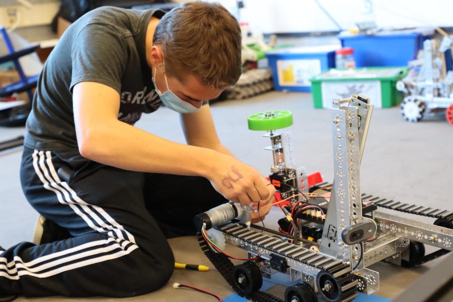 Freshman Joshua Nafziger helps construct the robot.
