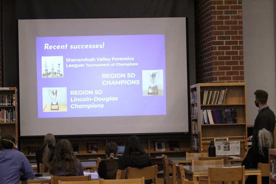Debate and English teacher Aaron Cosner displays the recent victories of the debate team. 