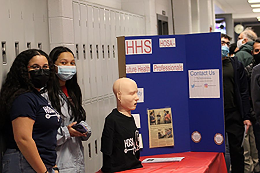 Sophomore Logaan Whiting (left) and senior Marelyn Rivera Rivas (right)  help run the HOSA table.