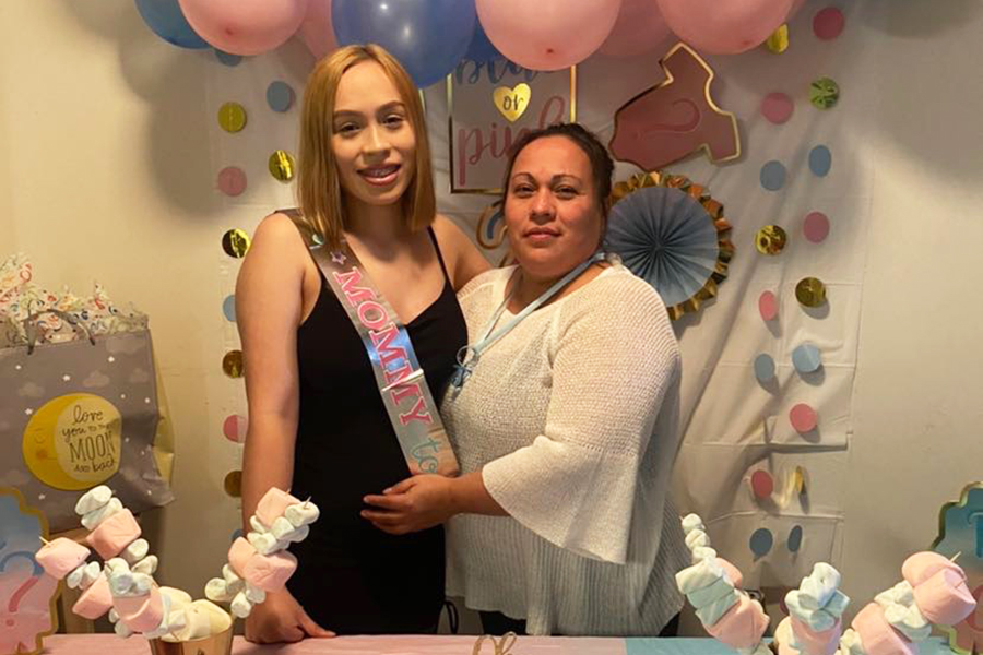 Senior Michelle Jurado poses with her mom at her gender reveal party. 