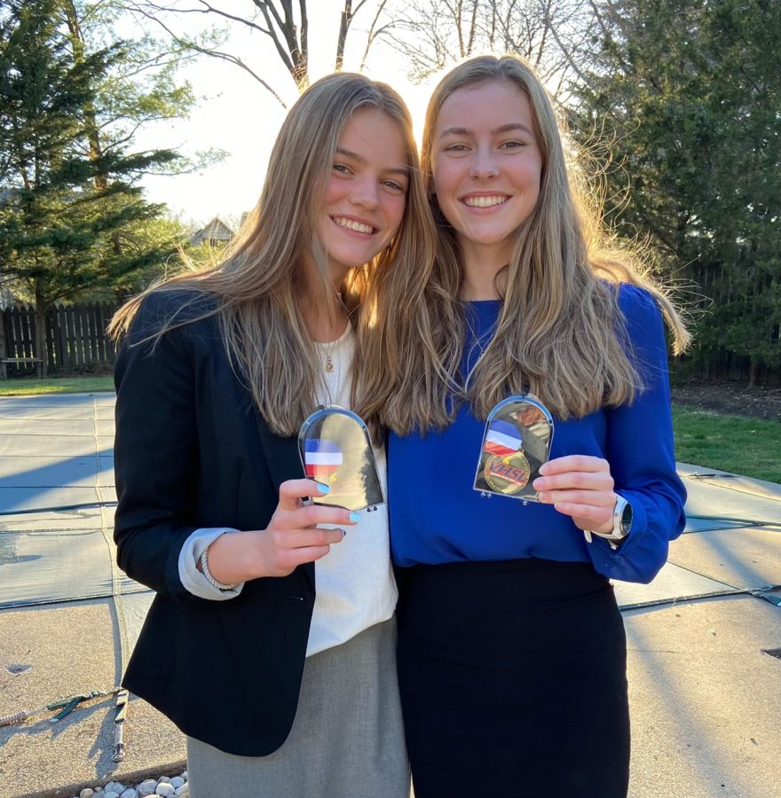 Sophomore Clare Kirwan and senior Kate Kirwan pose for a photo after their debate competition. 