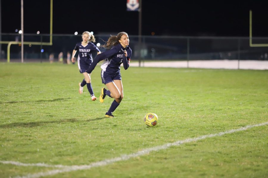 Senior Olivia King attempts to save a ball going out of bounds. 