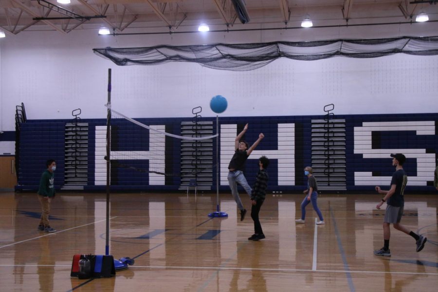 Sophomore Daniel Kirilyuk spikes the ball over the net.