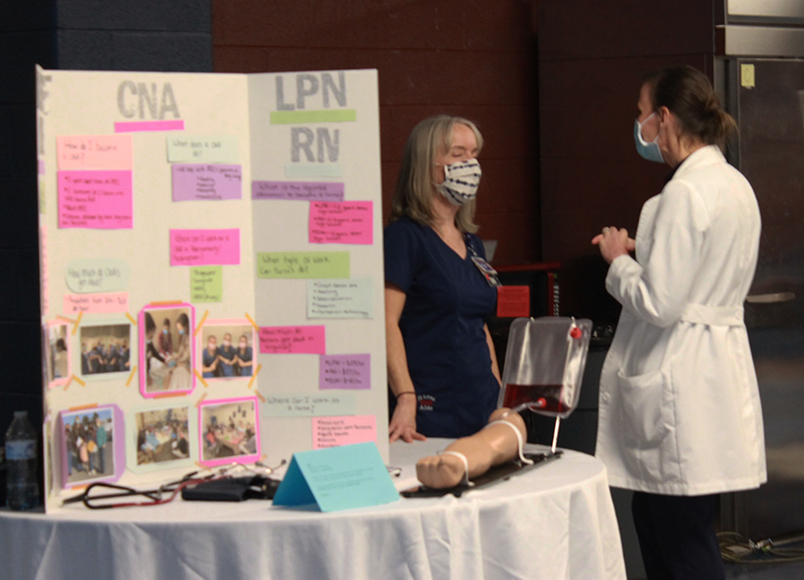 The CNA booth prepares for students to visit.