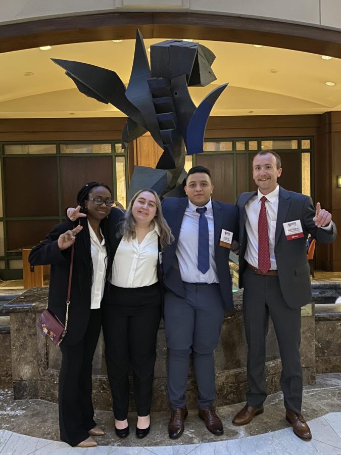 Sophomores Bimansha Huseni, Kaitlyn Stum, senior Carlos Bolanos and  FBLA director Matthew Denlinger pose for a picture after competing at the Virginia State Leadership Conference.