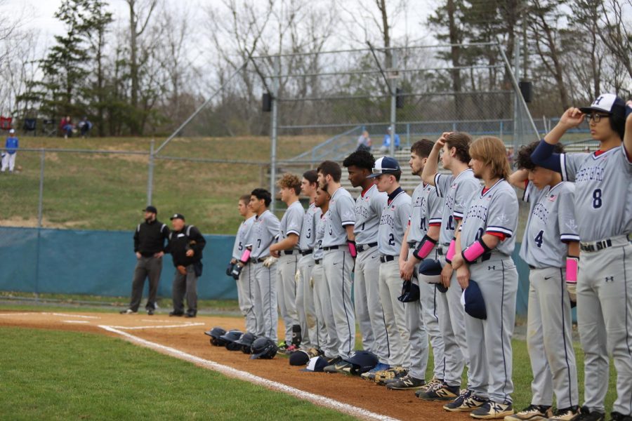 The varsity baseball team lines up for pregame announcements and the national anthem during a game earlier this season. 