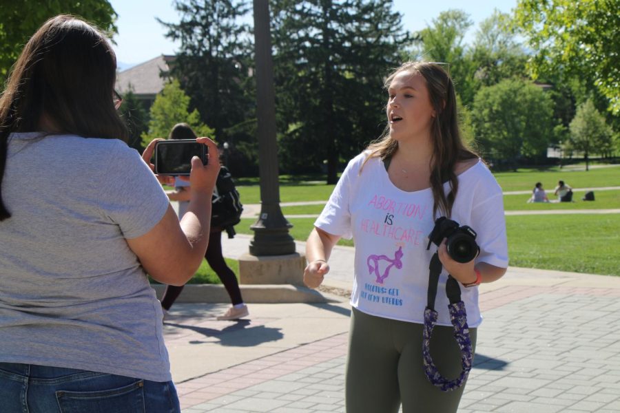 Abby Dotson films a video for her followers to encourage them to come out to the march. 