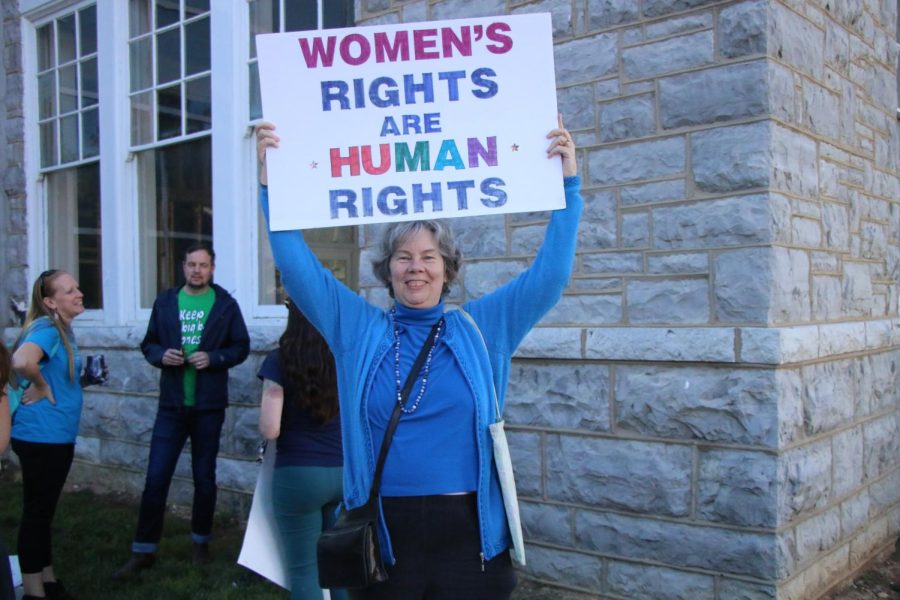 Laura Dent holds a sign that says womens rights are human rights. 