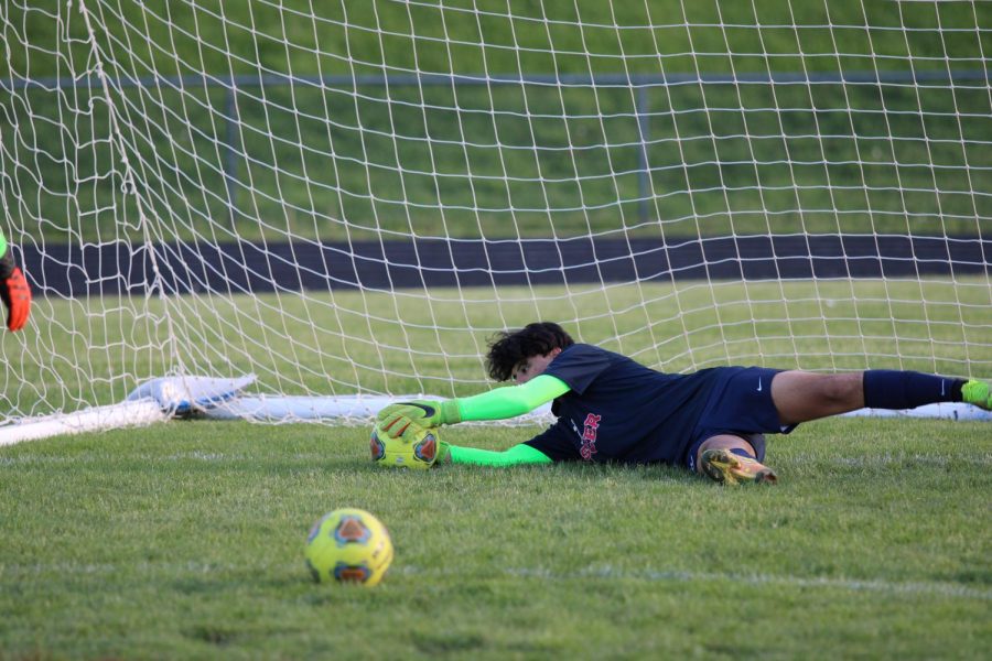 Senior Hector Hernandez warms up with the other keeper before the game.