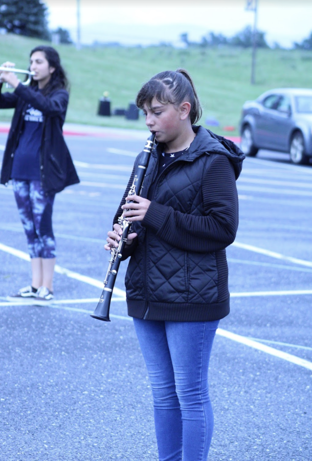 The band was instructed to practice playing a part of their music together. This student played the clarinet. 