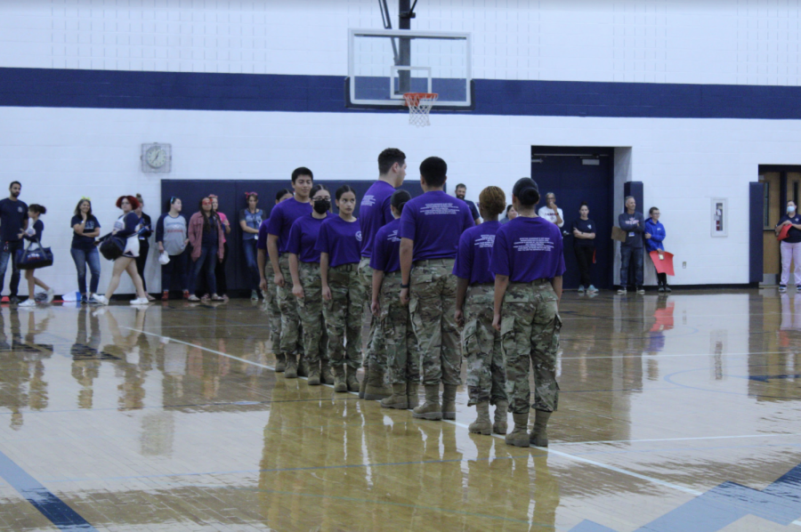JROTC forming in a line to start their performance for the upcoming freshman. 
