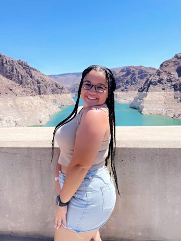 Junior Logaan Whiting smiles for a picture by Hoover Dam this summer.
