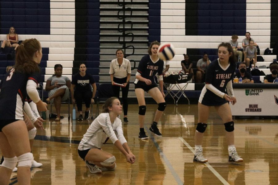 Sophomore Tegan Miller kneels to return the ball. Miller is the libero meaning she specializes in defence and doesnt serve or rotate the front line.   