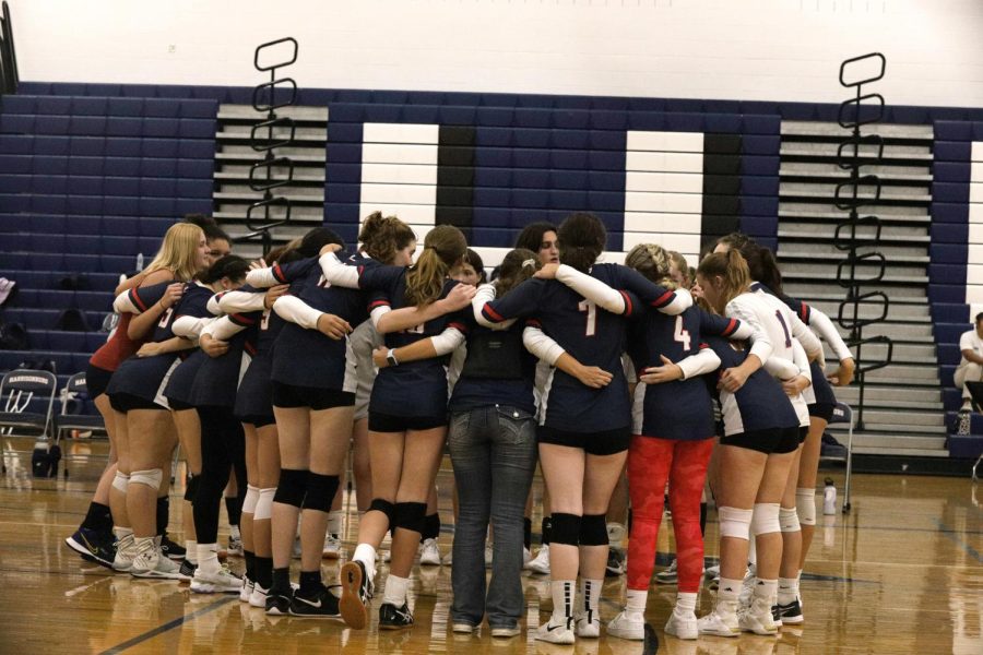 JV and Varsity volleyball team huddles before varsity game. The JV team lost 2-0 to the Patriots while varsity lost 3-0. 