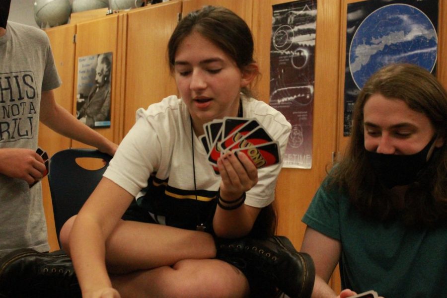 Claire (left) plays UNO with other board game club members. 