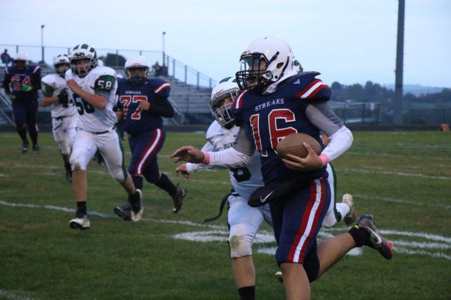 Eighth Grader Yandel Robles runs with the ball.