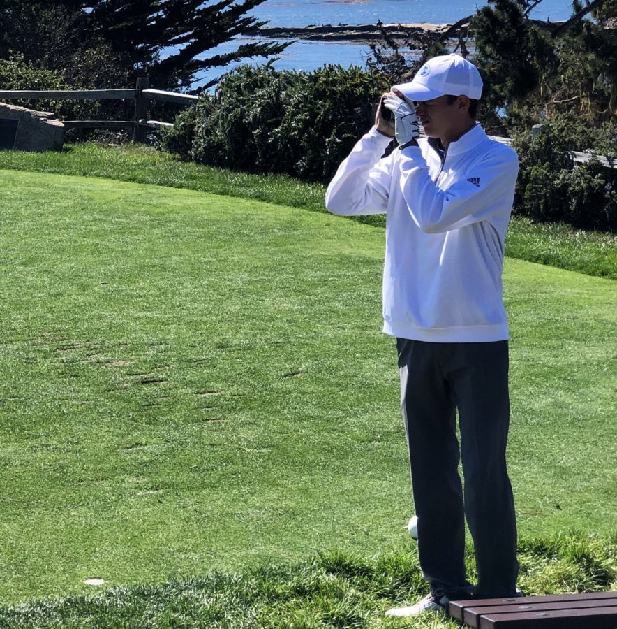 Corriston uses his range finder to determine his shot on hole five of Pebble Beach.