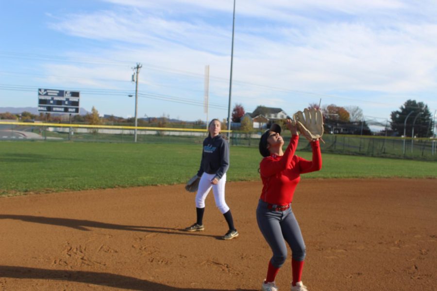 Junior Idaly Alvarez catches an infield pop fly at second base with sophomore McKenna Dayton backing her up. The two have been working on defensive plays during practice.  