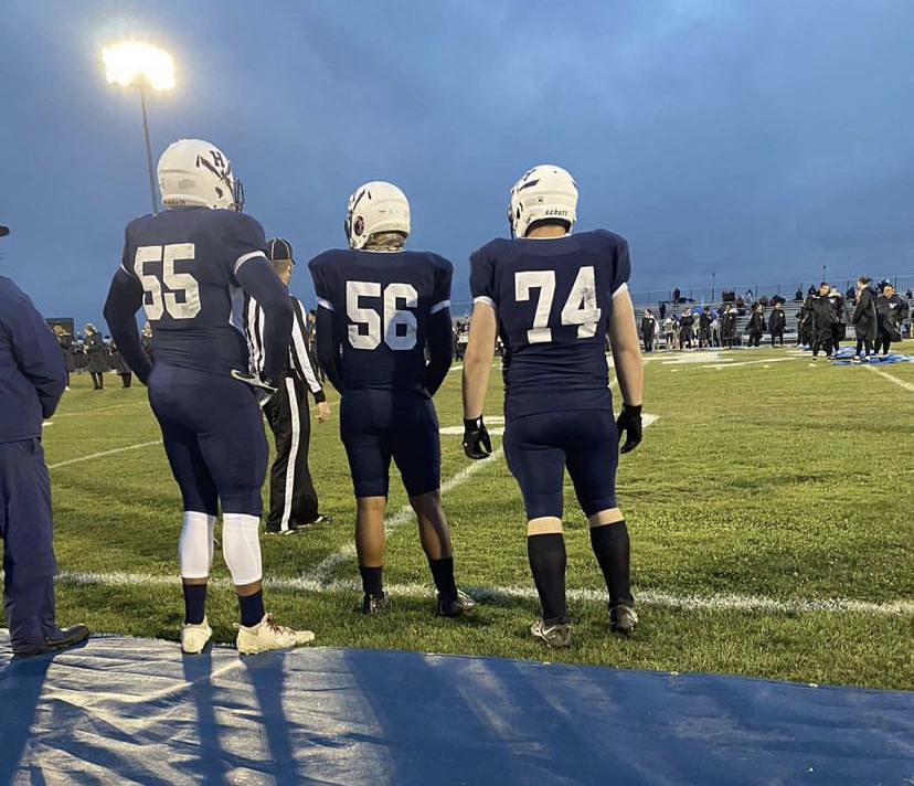 (55) Dontes Harvey-Wright, (56)Jayden Walker, and (74)Blake Tillman standing up while their teammates playes