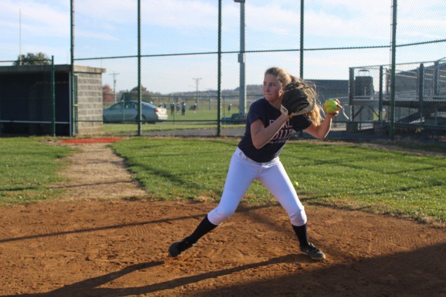 Sophmore McKenna Dayton practices her throw down from home to second base during off season practice. Dayton has been catching for the varsity team for two years now. 