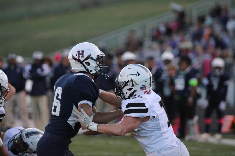 The Blue Streaks lay a block against a Turner Ashby edge rusher as the Streaks enter the redzone.