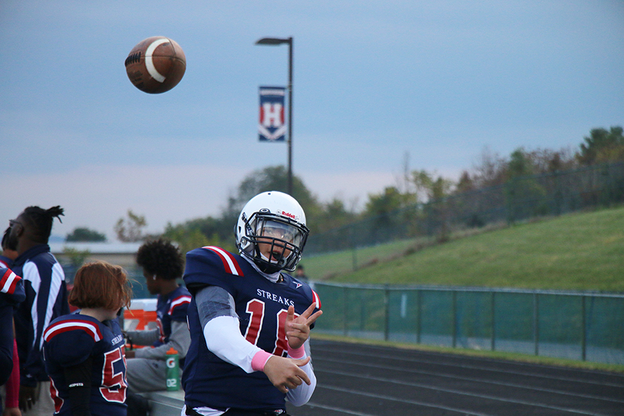 Eighth grader Yandel Robles warms up by throwing the ball.