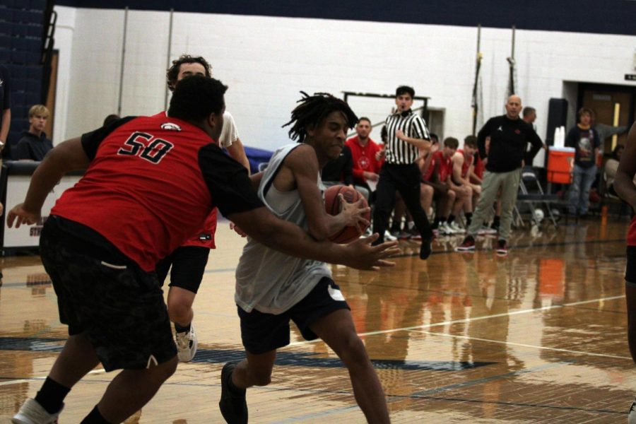 Junior, Xavier Williams runs down the court to shoot a basket. 