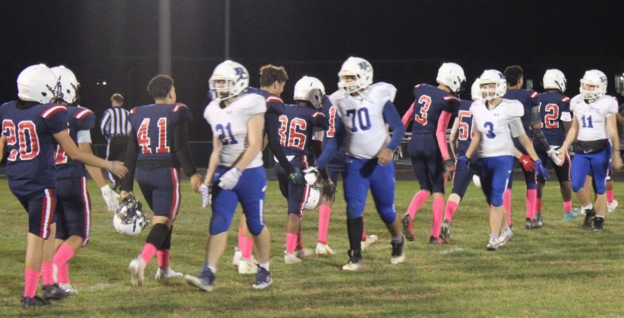 The Blue Streaks shake hands with opposing team. 