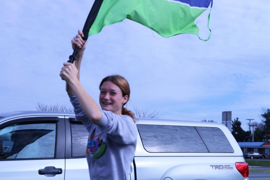 Senior Erin Newman puts her colorguard skills to use and runs around doing tricks with the flag. 