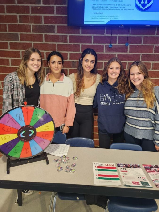 Sophomores Clare Kirwan, Soraya Kaussler, Lucy Ludwig, freshman Shirin Kaussler and senior Emma Swartz work the lunch table to inform students of the events happening in Iran.