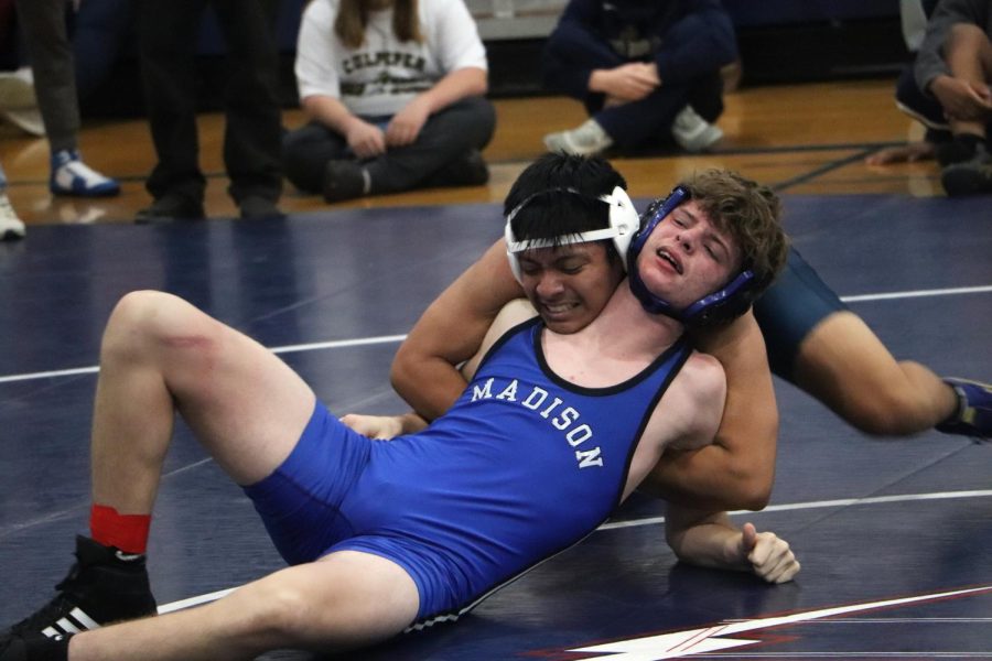 Senior Ty Hass grabs onto his opponent from Madison County High School. 