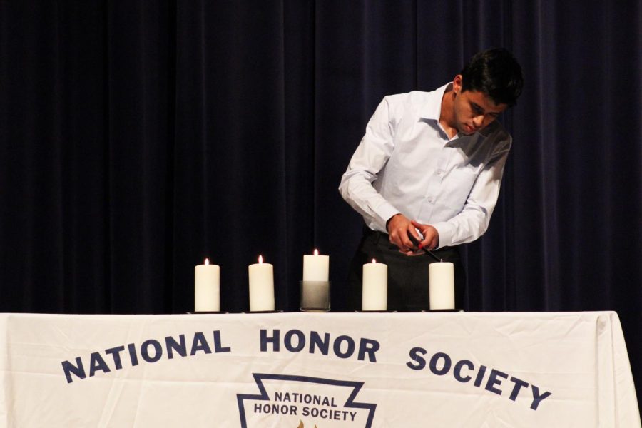Senior Niranjan Aradhey lights the candle that symbolized character. 