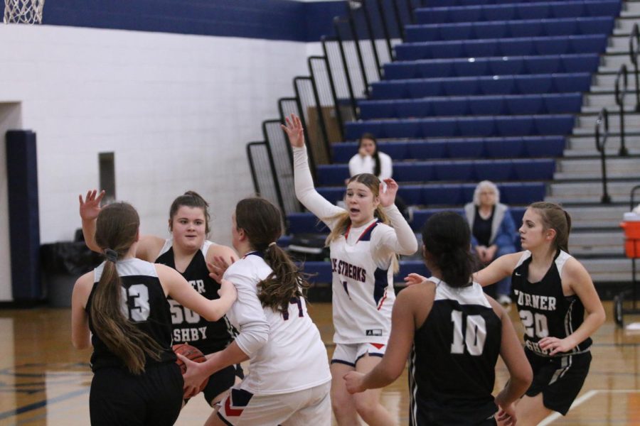 Eighth grade Weakley Addison gets help from Eighth grader Cain Sierra and together they make the shot.