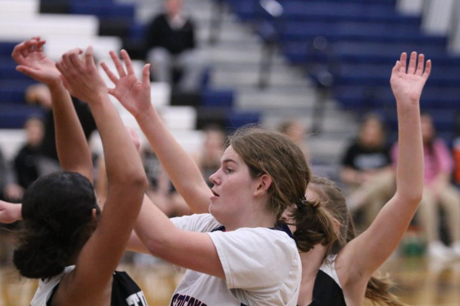 Eighth grader Sophomore Rupe Lily isn't giving the ball away when the other team is snatching it away.